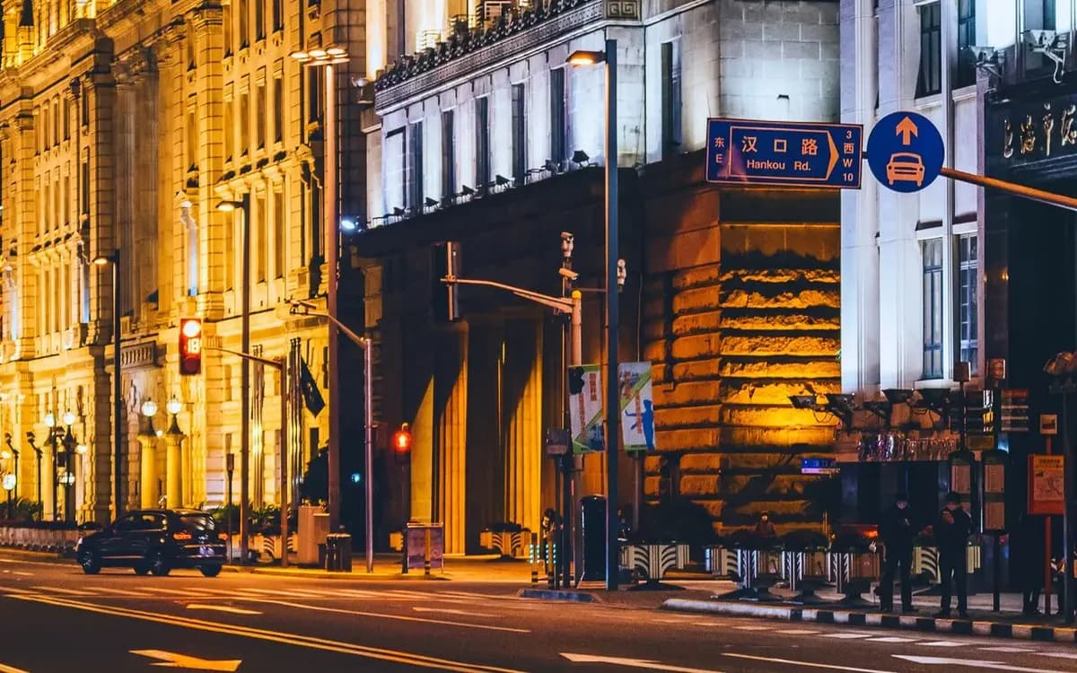 Historic buildings lit along a central Shanghai street at night
