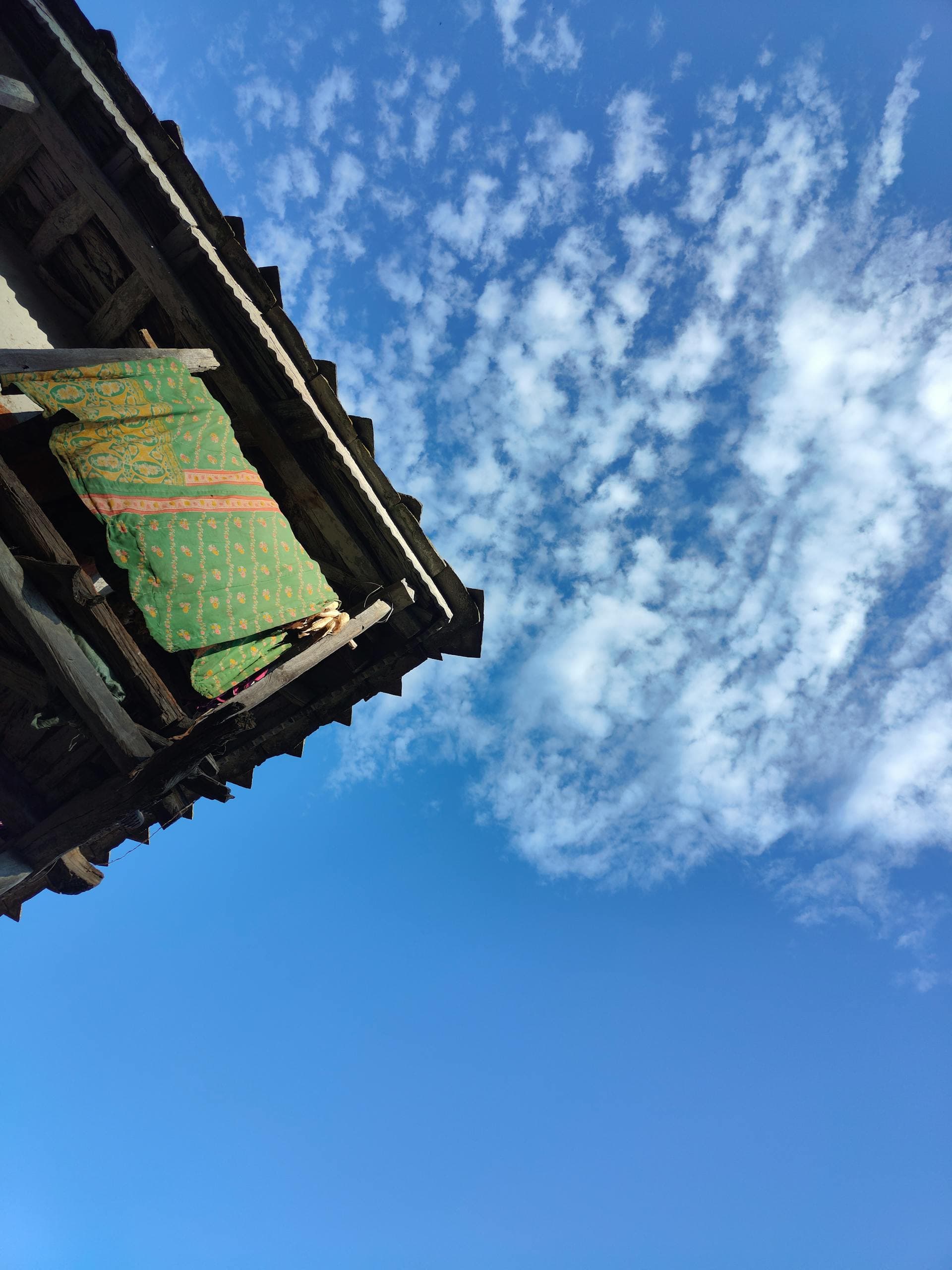 A Bai village on the shore of Erhai Lake, with clouds gathering on the Cangshan range