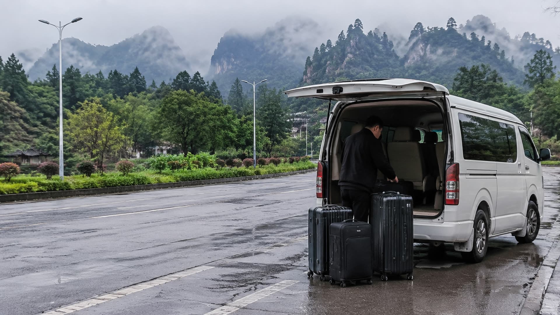 Private van and luggage on a rainy Zhangjiajie transfer road