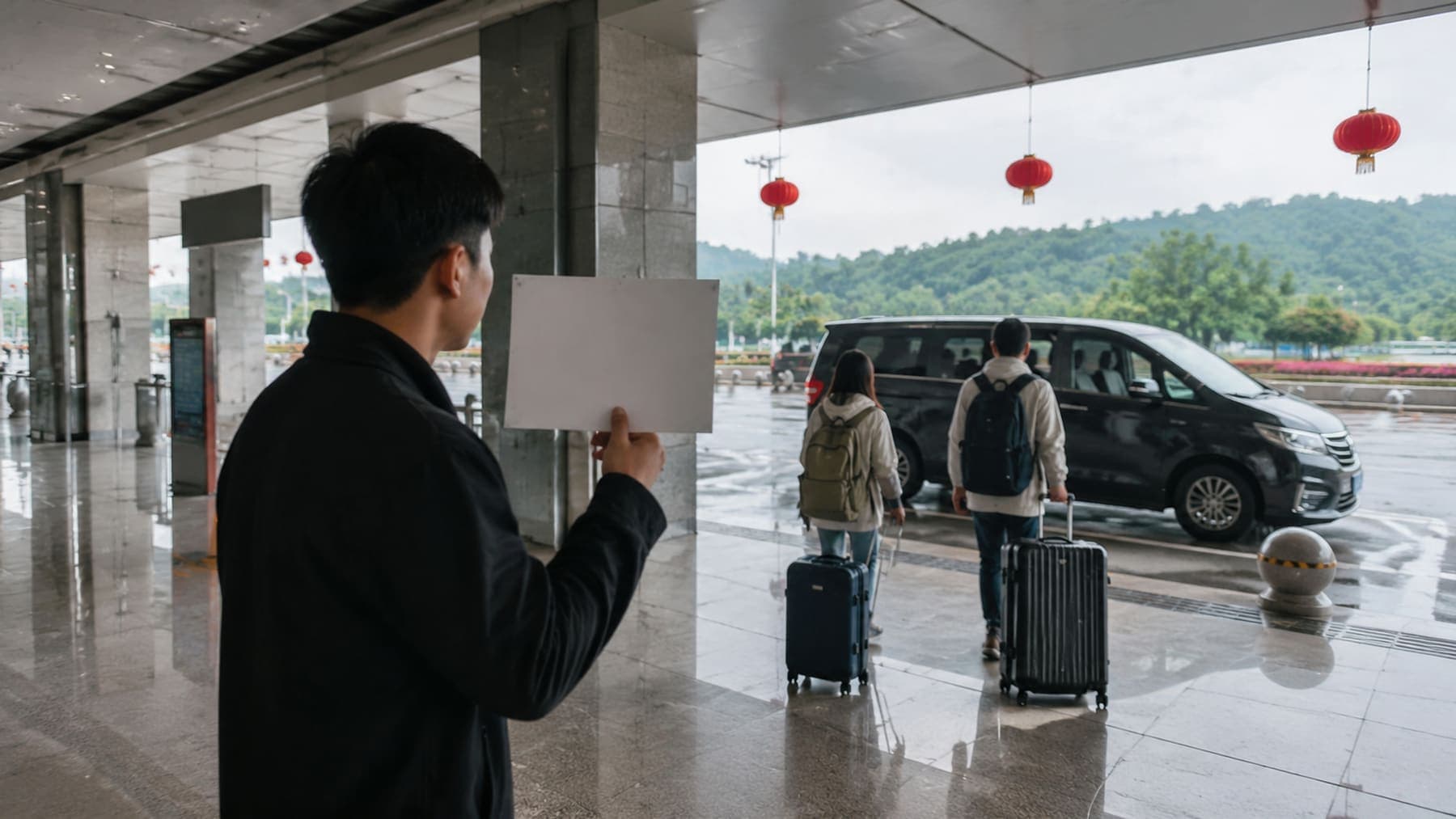 Local guide meeting travelers in the arrival hall for a Zhangjiajie trip