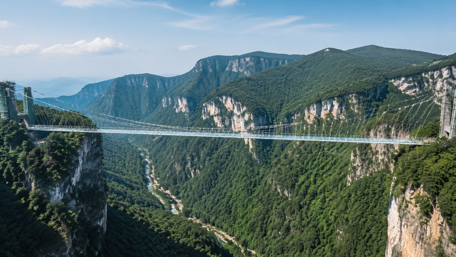 Zhangjiajie Grand Canyon glass bridge stretching across green cliffs