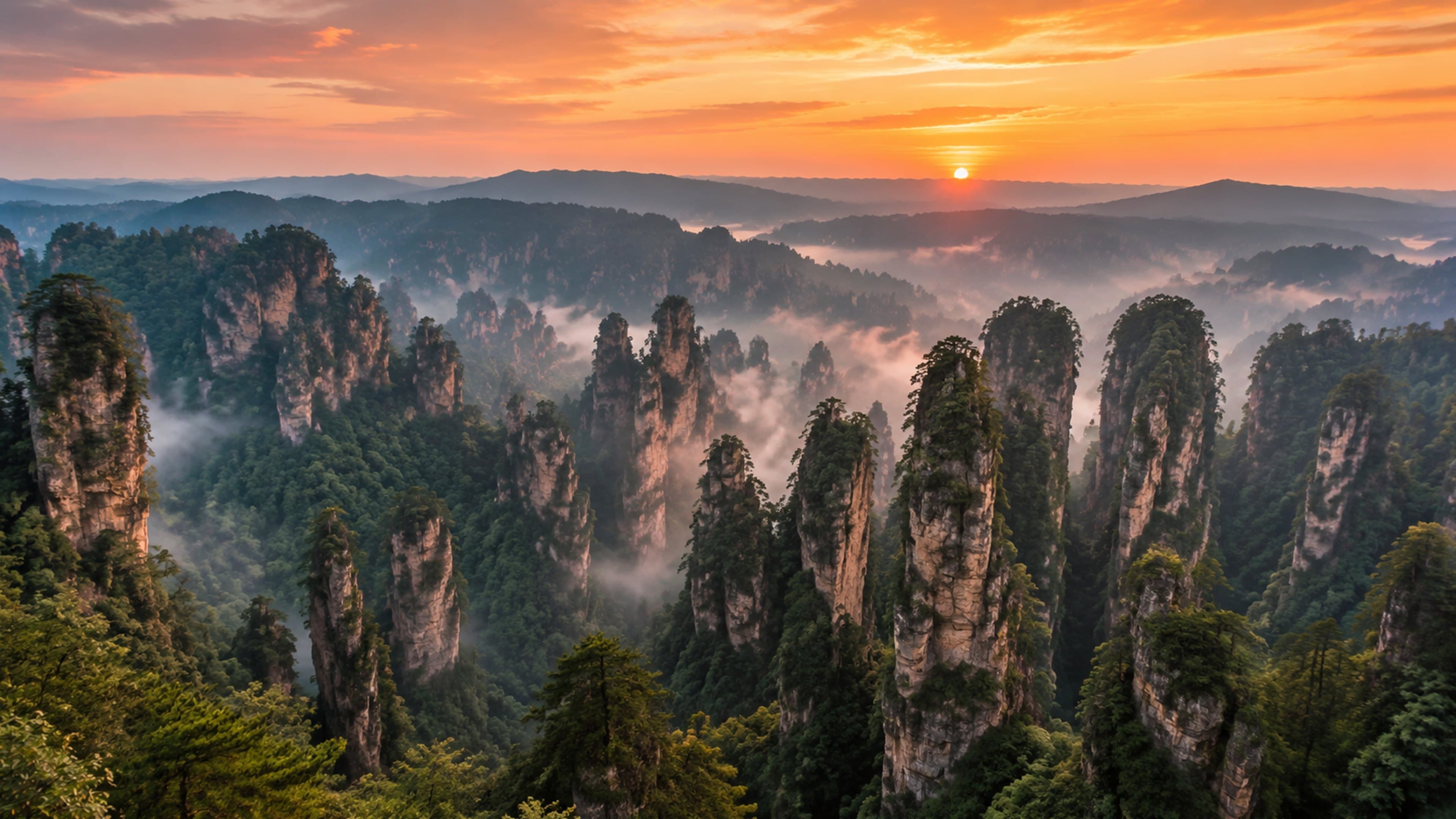 Warm light opening across Zhangjiajie sandstone pillars