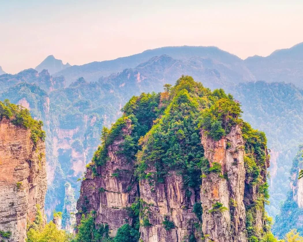 Green sandstone peaks rising through summer mist in Zhangjiajie