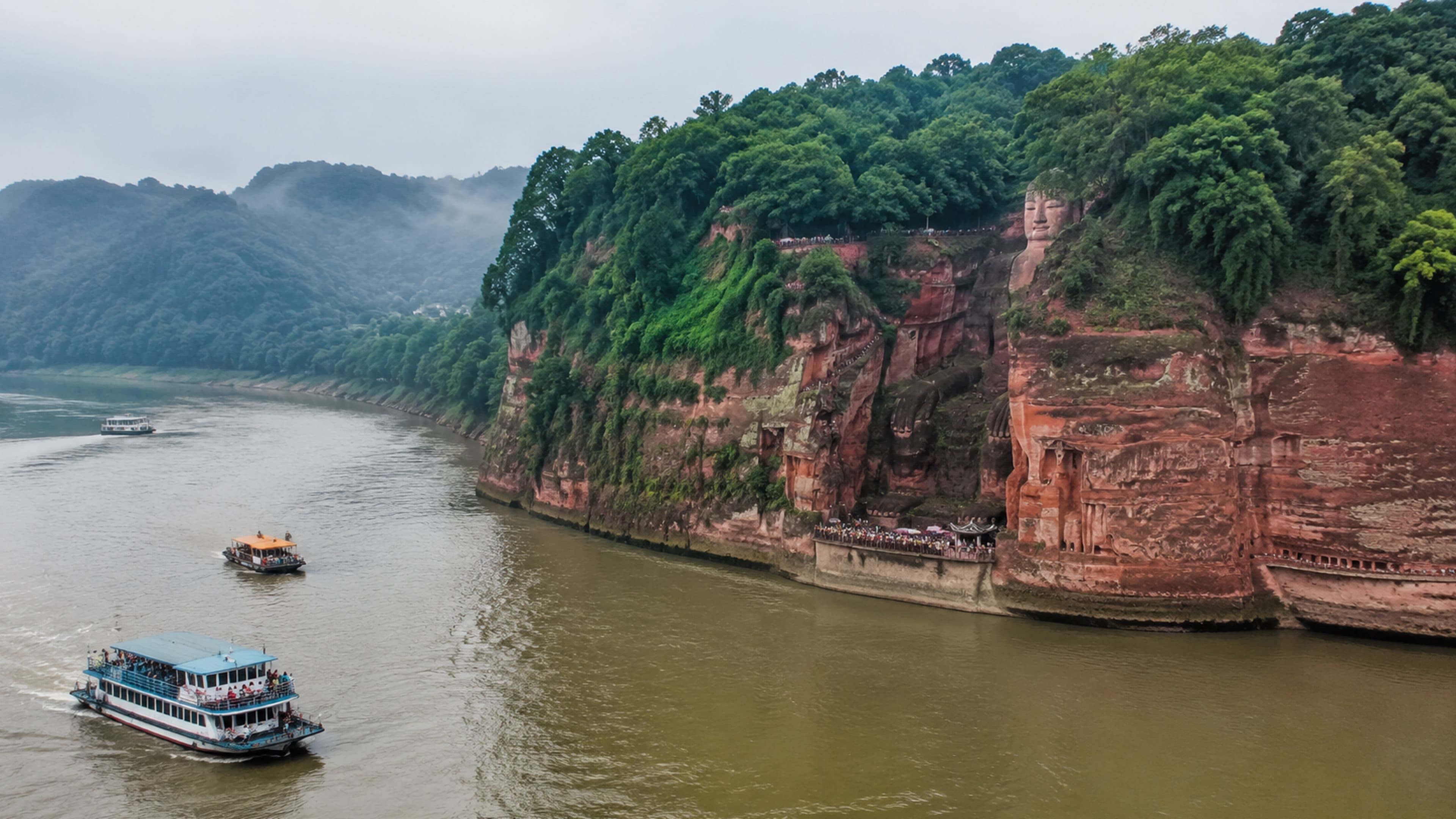 Leshan river bend and red sandstone cliff showing the Buddha scale